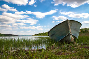 lonely boat on the lake shore. Vintage view